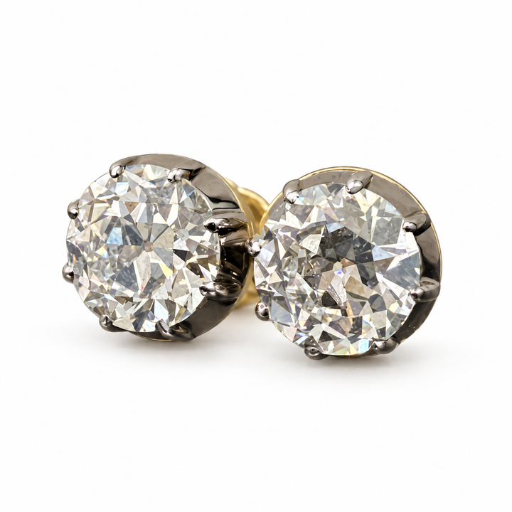 Old European-cut lab-grown diamond stud earrings in 18K yellow gold, 2 ct each pair with dark settings on white background