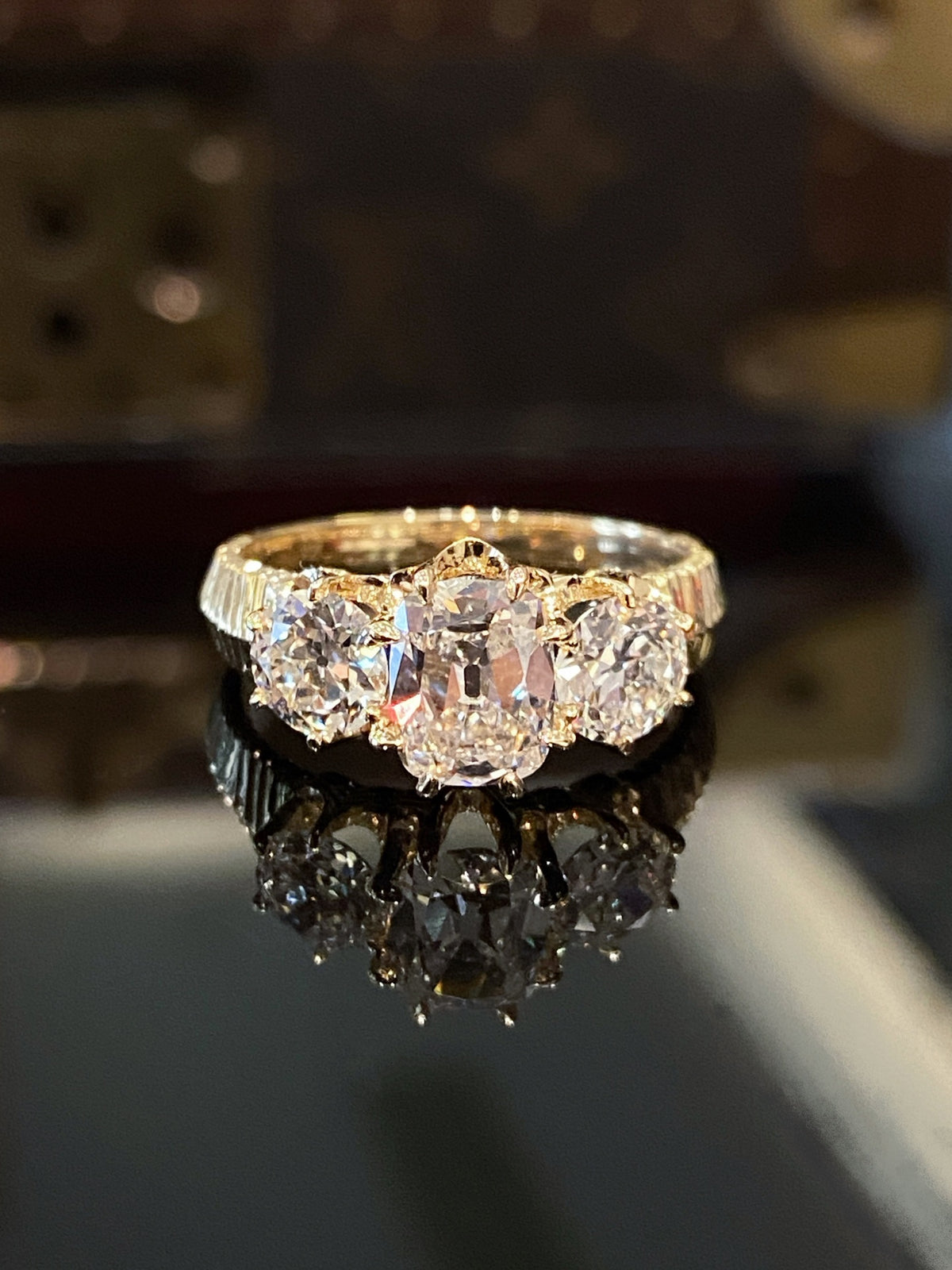 Old Mine-cut three-stone diamond ring in yellow gold, original frontal view