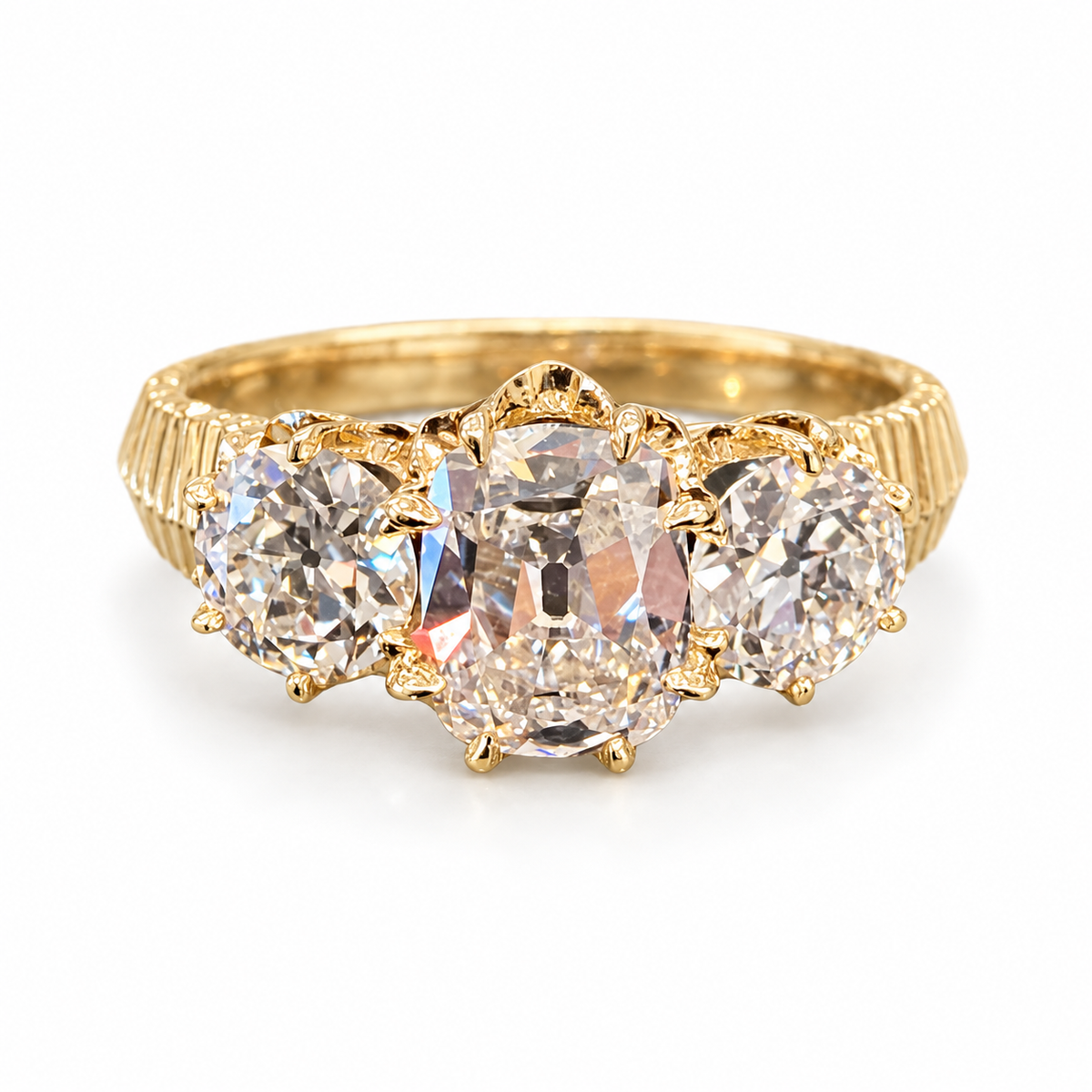 Old Mine-cut three-stone lab-grown diamond ring in 18K yellow gold, elongated cushion center, two smaller side diamonds and fluted shoulders on white