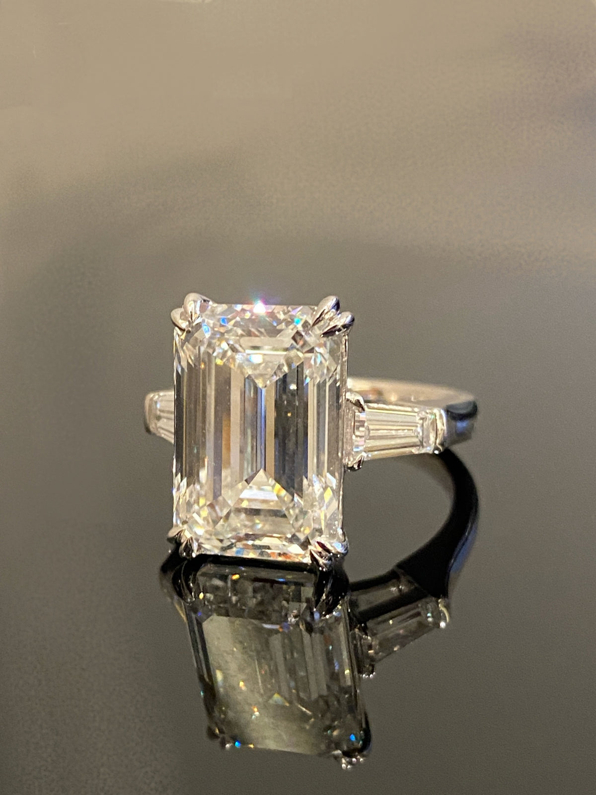 Emerald-cut three-stone diamond ring, original angled frontal view
