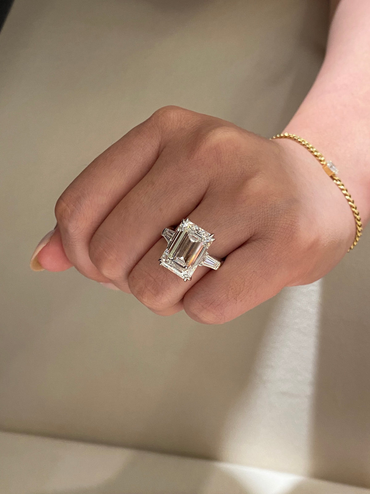 Emerald-cut three-stone diamond ring, original wearing view 2; bracelet not included