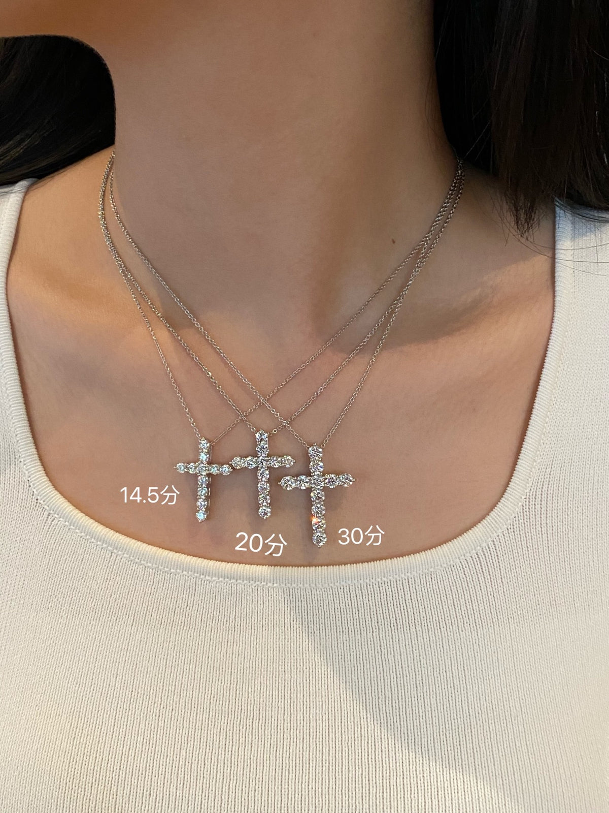 Round diamond cross necklace comparison with14.5,20and30-point examples; selected30-point,3.3ct necklace supplied