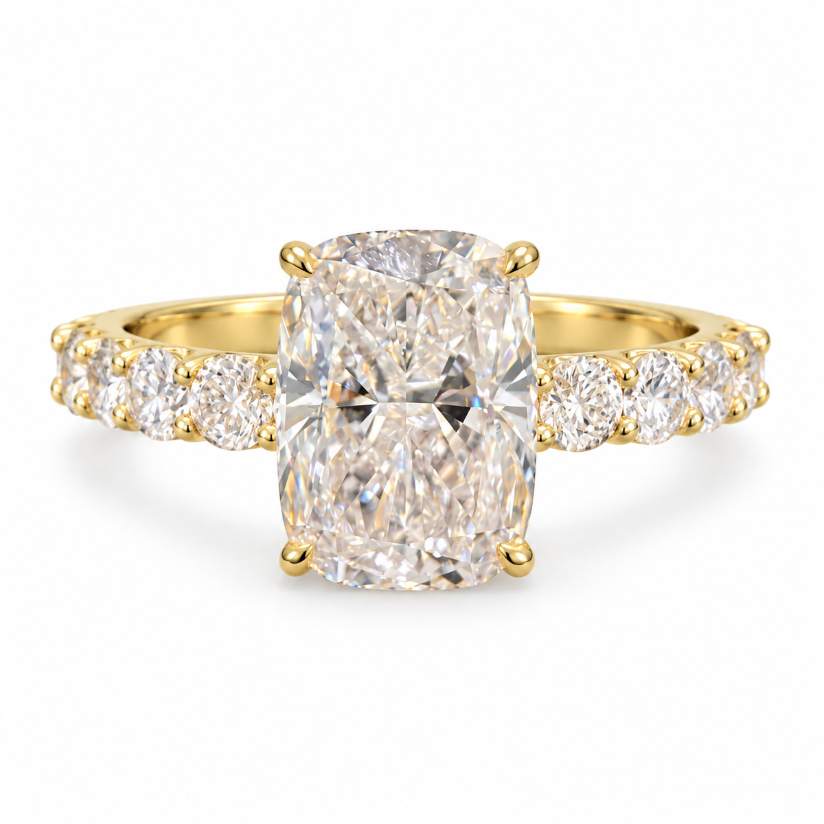 Elongated cushion lab-grown diamond ring in 18K yellow gold with four corner prongs and round diamond shoulders on white