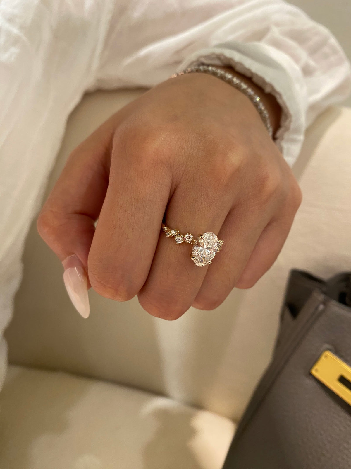 Oval diamond ring with geometric shoulders, original yellow-gold wearing view 2