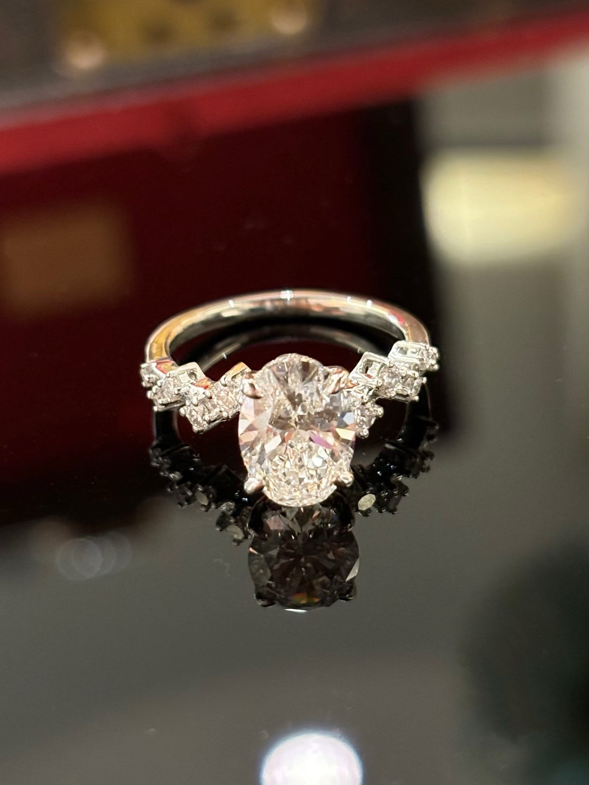Oval diamond ring with geometric diamond-set shoulders, original white-gold frontal view