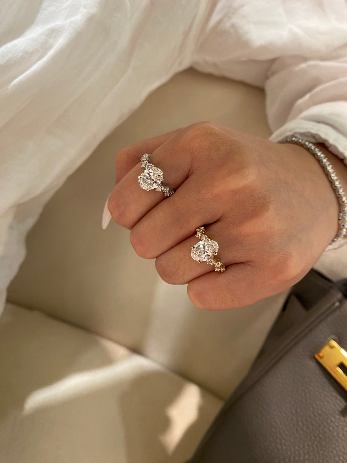 Oval diamond rings with geometric shoulders, original two-color wearing view; other jewelry not included