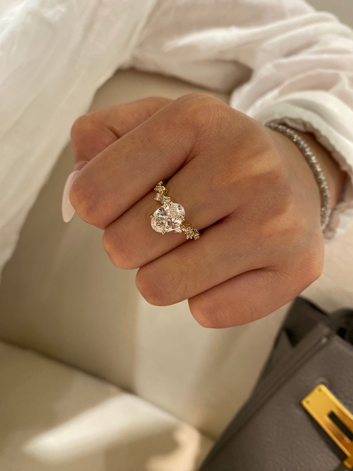 Oval diamond ring with geometric shoulders, original yellow-gold wearing view 1
