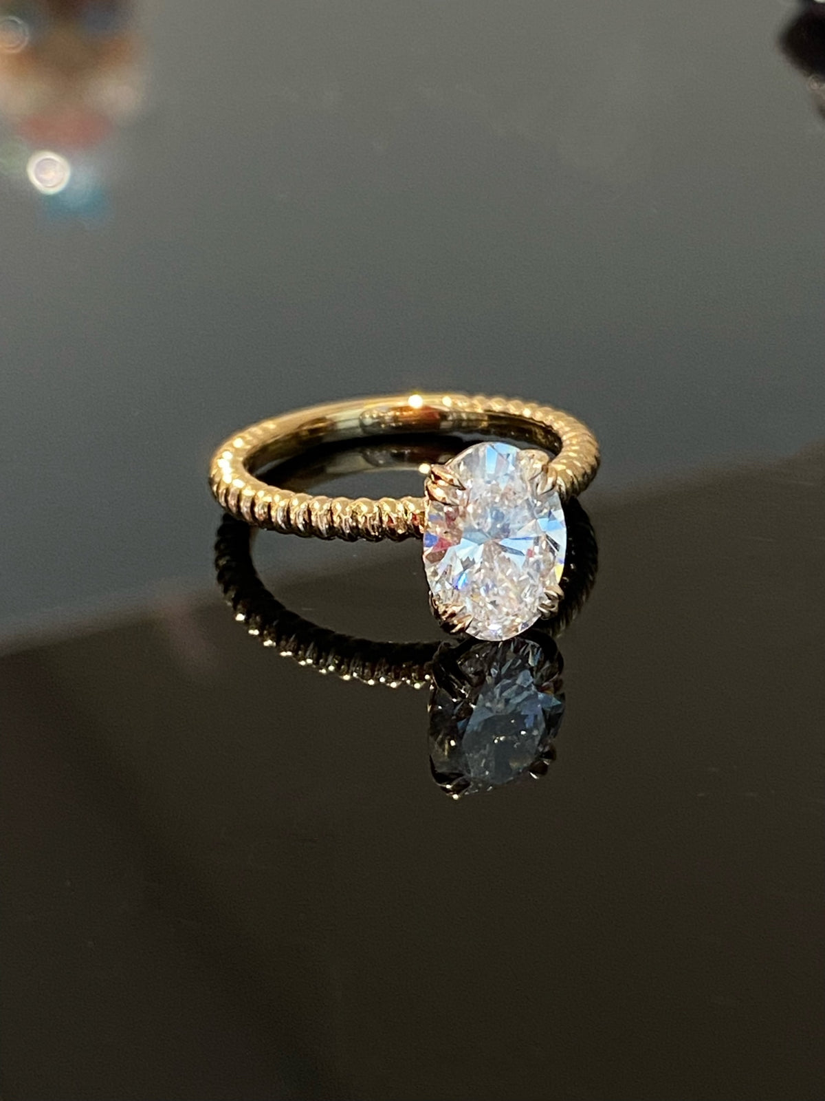Oval rope-band diamond ring, yellow-gold reference version, original angled view