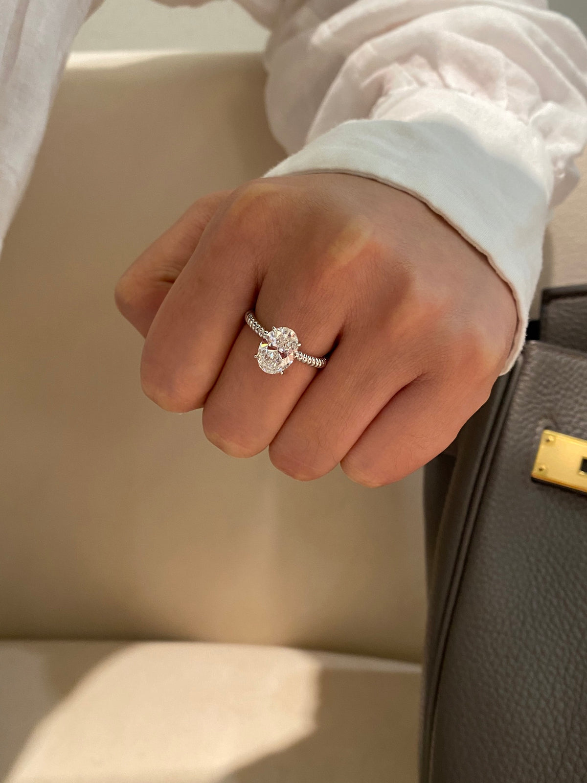 Oval diamond rope-band ring in white platinum, original wearing view 2; other jewelry not included