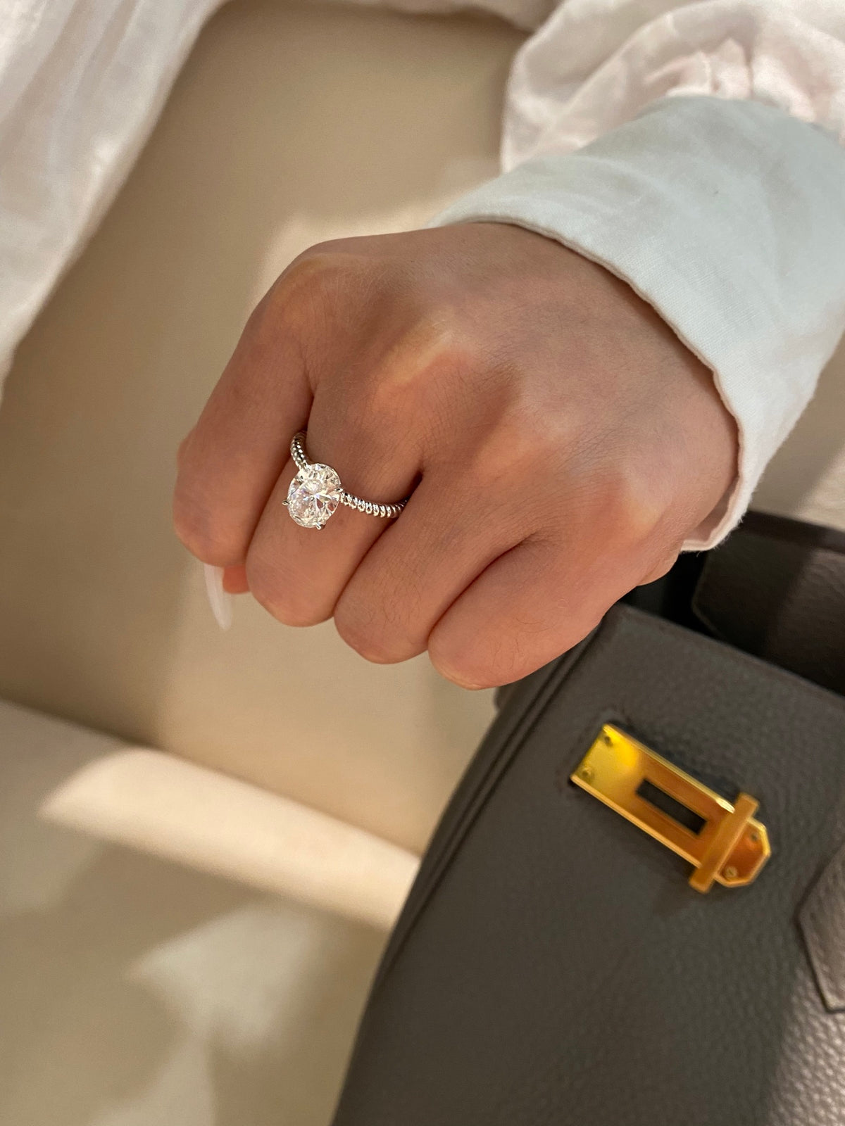 Oval diamond rope-band ring in white platinum, original wearing view 4; other jewelry not included