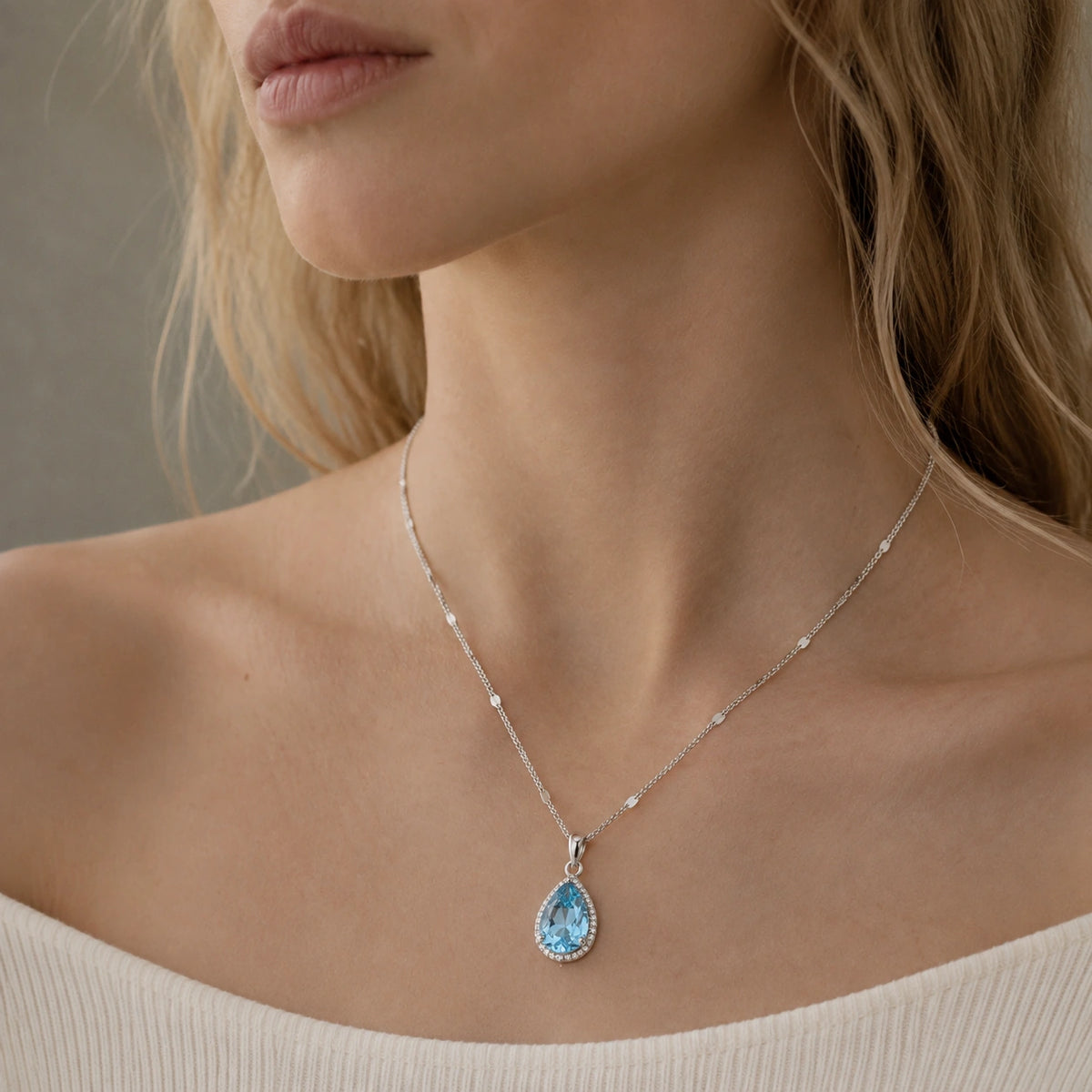 When the Rain Let Go — blue topaz pendant, AI-assisted editorial wearing view [asset:7fa18eebfdfa]